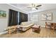Bright living room with hardwood floors, a modern ceiling fan, and stylish decor at 4007 S Renellie Dr, Tampa, FL 33611