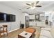 Open-concept living area with hardwood floors, white cabinets, and modern stainless steel appliances at 4007 S Renellie Dr, Tampa, FL 33611