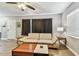Comfortable living room featuring a couch, hardwood floors, and a bright window with blinds at 4007 S Renellie Dr, Tampa, FL 33611