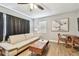 Inviting living room with hardwood floors, a neutral-toned sofa, and a modern ceiling fan at 4007 S Renellie Dr, Tampa, FL 33611