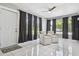 Living room featuring a front door, tile flooring, and lots of natural light at 4007 S Renellie Dr, Tampa, FL 33611