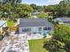 Outside entertaining is easy in this backyard with mature trees and patio seating at 4007 S Renellie Dr, Tampa, FL 33611