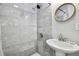 Close up of a marble tiled shower with matte black shower head and faucet at 4007 S Renellie Dr, Tampa, FL 33611