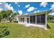 Exterior shot featuring a screened-in patio, manicured lawn, and a well-maintained home exterior at 4646 Lacrosse Ct, New Port Richey, FL 34655