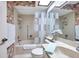 Bathroom with tub-shower combo, vanity, and flamingo wallpaper at 4646 Lacrosse Ct, New Port Richey, FL 34655