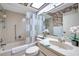 Bright bathroom featuring a tub/shower combo, skylight, and vanity at 4646 Lacrosse Ct, New Port Richey, FL 34655