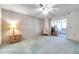 Large bedroom featuring a ceiling fan, sliding glass door access, and a small accent table at 4646 Lacrosse Ct, New Port Richey, FL 34655