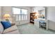 Bright bedroom with a couch, desk, and shelving at 4646 Lacrosse Ct, New Port Richey, FL 34655
