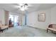 Large bedroom with ceiling fan, carpet, and sliding glass door access to sun room at 4646 Lacrosse Ct, New Port Richey, FL 34655