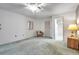 Bright bedroom featuring a ceiling fan, ensuite bathroom, and a neutral color palette at 4646 Lacrosse Ct, New Port Richey, FL 34655