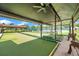 Community bocce ball courts with covered seating and a view of a tennis court at 4646 Lacrosse Ct, New Port Richey, FL 34655
