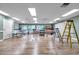 Well-lit room in the clubhouse equipped with tables, tools, and a ladder at 4646 Lacrosse Ct, New Port Richey, FL 34655