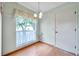 Bright dining area featuring hard wood floors, a garden window, and elegant chandelier at 4646 Lacrosse Ct, New Port Richey, FL 34655