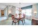 Elegant dining room featuring a chandelier, large window, and plenty of light at 4646 Lacrosse Ct, New Port Richey, FL 34655