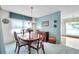 Bright dining room with a chandelier and seating for four at 4646 Lacrosse Ct, New Port Richey, FL 34655