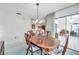 Dining room with a view of the living room and sliding glass doors at 4646 Lacrosse Ct, New Port Richey, FL 34655