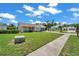 Single-story home featuring a covered porch, well-kept lawn, and low shrubs lining the foundation at 4646 Lacrosse Ct, New Port Richey, FL 34655