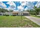 Charming single-story home with screened-in garage, well-maintained lawn, and inviting front porch at 4646 Lacrosse Ct, New Port Richey, FL 34655