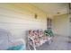 Cozy front porch with swing, rocking chair, and decorative accents next to the front door at 4646 Lacrosse Ct, New Port Richey, FL 34655