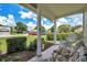 Inviting front porch features comfortable seating, lush greenery, and a view of the well-maintained lawn at 4646 Lacrosse Ct, New Port Richey, FL 34655