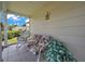 Inviting front porch with swing, chair and plants at 4646 Lacrosse Ct, New Port Richey, FL 34655