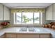 Bright kitchen showcasing a window above the sink and white countertops with decor at 4646 Lacrosse Ct, New Port Richey, FL 34655