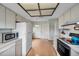Well-lit kitchen with laminate wood flooring, white countertops and white appliances at 4646 Lacrosse Ct, New Port Richey, FL 34655