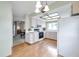 Bright kitchen with hardwood floors, a window over the sink, white cabinets, and black appliances at 4646 Lacrosse Ct, New Port Richey, FL 34655