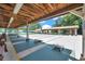 Well-maintained shuffleboard courts with covered seating and landscaping in a community setting at 4646 Lacrosse Ct, New Port Richey, FL 34655