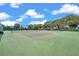 This community includes a pristine tennis court surrounded by lush greenery and clear blue skies at 4646 Lacrosse Ct, New Port Richey, FL 34655