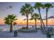 Tropical beachfront view with palm trees and a scenic sunset over the ocean at 4939 Floramar Ter # 203, New Port Richey, FL 34652