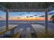 Framed sunset view from a beach pavilion with picnic tables at 4939 Floramar Ter # 203, New Port Richey, FL 34652