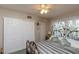 Inviting bedroom featuring a decorative headboard, closet, and soft, natural light at 4939 Floramar Ter # 203, New Port Richey, FL 34652