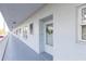 Well-maintained building exterior with access to the unit, enhanced by a decorative wreath at 4939 Floramar Ter # 203, New Port Richey, FL 34652