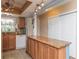 Charming kitchen island with granite countertop, storage, and modern appliances for delightful cooking experiences at 4939 Floramar Ter # 203, New Port Richey, FL 34652