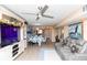 Open-concept living room and dining area with a ceiling fan and stylish furnishings at 4939 Floramar Ter # 203, New Port Richey, FL 34652