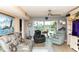 Cozy living room featuring a sofa, recliners, and a scenic view overlooking the waterway at 4939 Floramar Ter # 203, New Port Richey, FL 34652