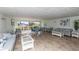 Bright community lounge area with comfortable seating, tile flooring, and a large window offering outdoor views at 4939 Floramar Ter # 203, New Port Richey, FL 34652