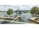 Scenic marina view with boats docked and palm trees swaying in the background, under a partly cloudy sky at 4939 Floramar Ter # 203, New Port Richey, FL 34652