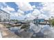 Picturesque marina showcasing various boats docked near a building, with a reflective water surface under a cloudy sky at 4939 Floramar Ter # 203, New Port Richey, FL 34652