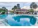 Community outdoor swimming pool with lounge chairs and a shaded pavilion, offering a relaxing waterfront view at 4939 Floramar Ter # 203, New Port Richey, FL 34652