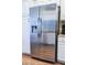 Stainless steel Frigidaire refrigerator with water and ice dispenser, surrounded by white cabinets at 4939 Floramar Ter # 203, New Port Richey, FL 34652