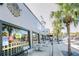 Sidewalk dining at a restaurant with a tropical exterior and palm trees at 4939 Floramar Ter # 203, New Port Richey, FL 34652
