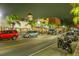 Night scene of a vibrant street with illuminated storefronts and palm trees at 4939 Floramar Ter # 203, New Port Richey, FL 34652