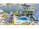 Aerial view of community pool, gazebo, boat docks, and condo building at 4939 Floramar Ter # 812, New Port Richey, FL 34652