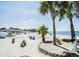 This beach has a sandy shore, a few palm trees, and calm waters at 4939 Floramar Ter # 812, New Port Richey, FL 34652