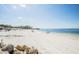 Expansive beach with calm water and a clear sky, ideal for leisurely strolls and relaxation at 4939 Floramar Ter # 812, New Port Richey, FL 34652