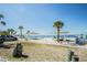 This beach features covered picnic tables, a sandy shore, and turquoise water at 4939 Floramar Ter # 812, New Port Richey, FL 34652
