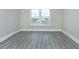 Bedroom with a window and gray floors, providing a clean and modern aesthetic at 4939 Floramar Ter # 812, New Port Richey, FL 34652