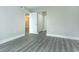 Neutral bedroom with gray flooring, closet, and a hallway view, offering ample space at 4939 Floramar Ter # 812, New Port Richey, FL 34652